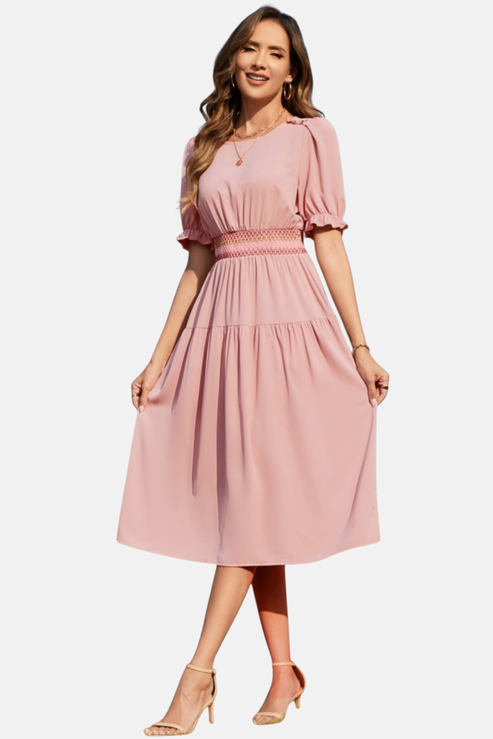Woman wearing a pink dress on a white background