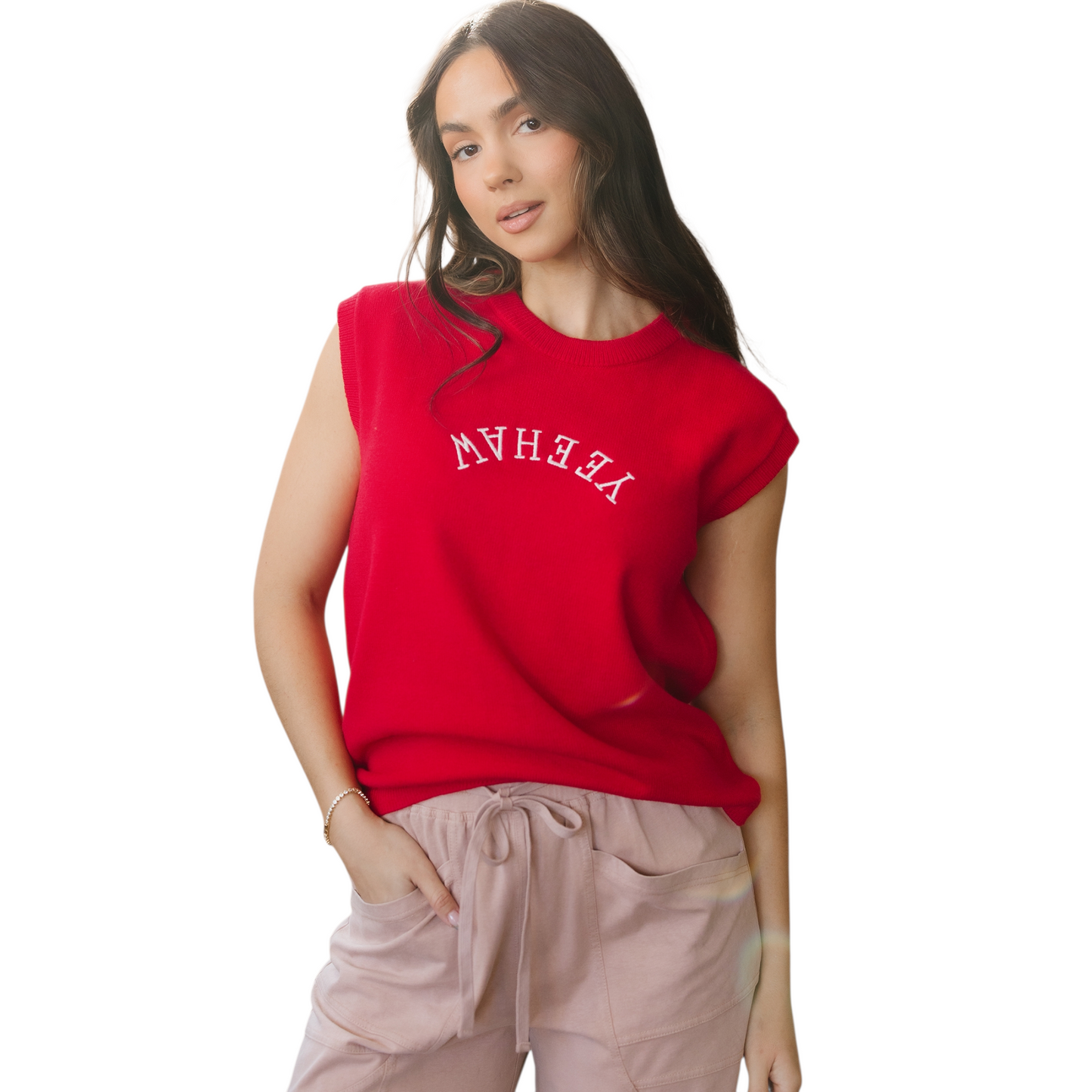Model wearing a vibrant red sleeveless knit vest with white "YEEHAW" embroidery in a western font across the chest.