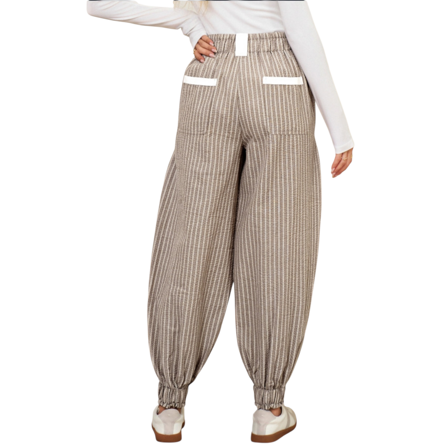 Striped pants worn by a person on a white background