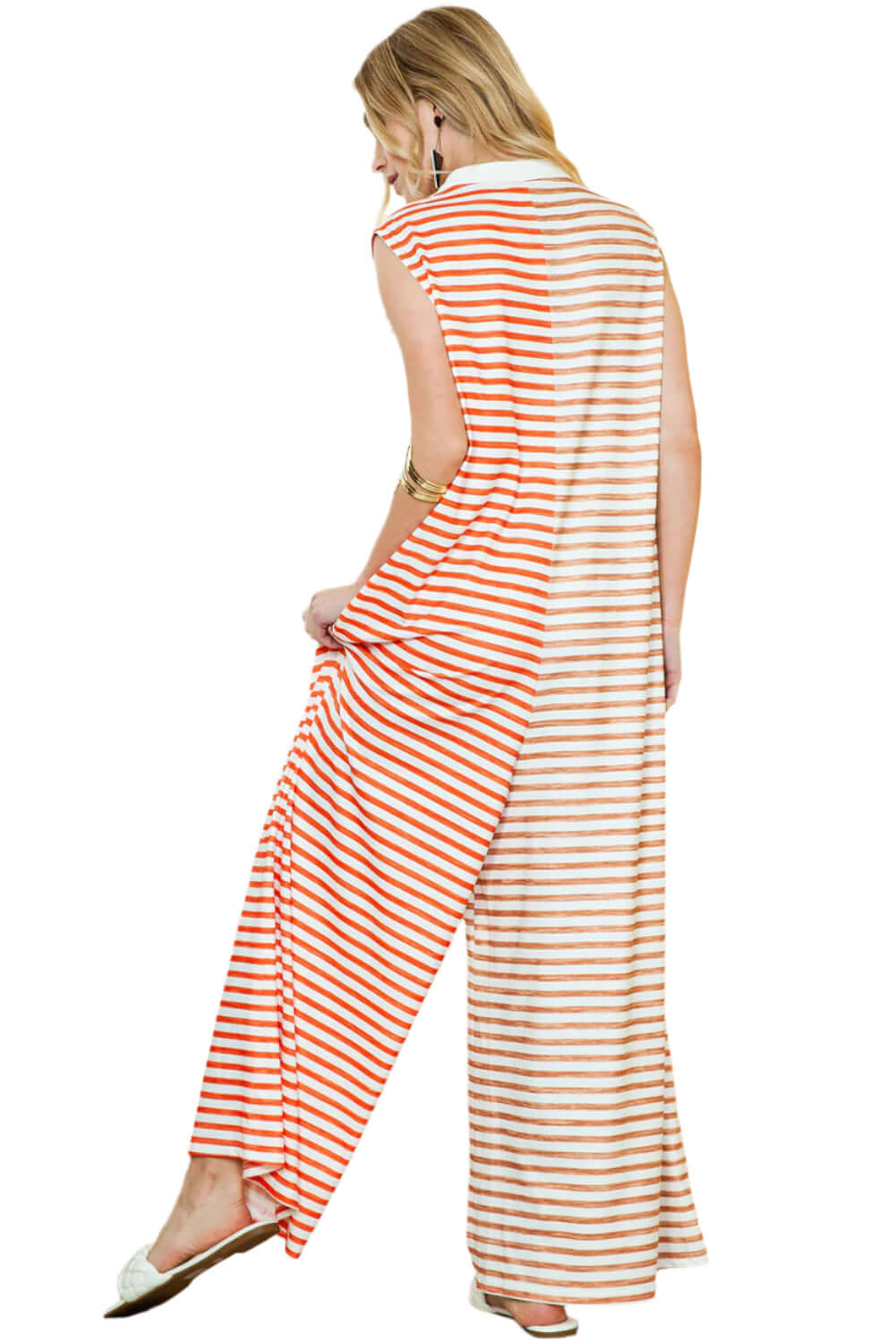 Effortlessly chic orange striped jumpsuit with a versatile wide-leg design. Back view.