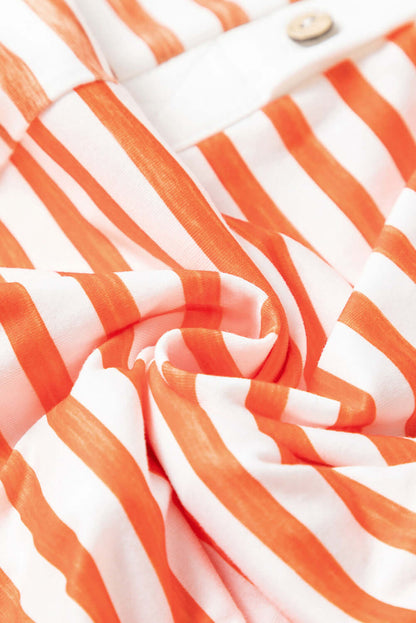 Closed up fabric view of an orange striped wide-leg jumpsuit with pockets.