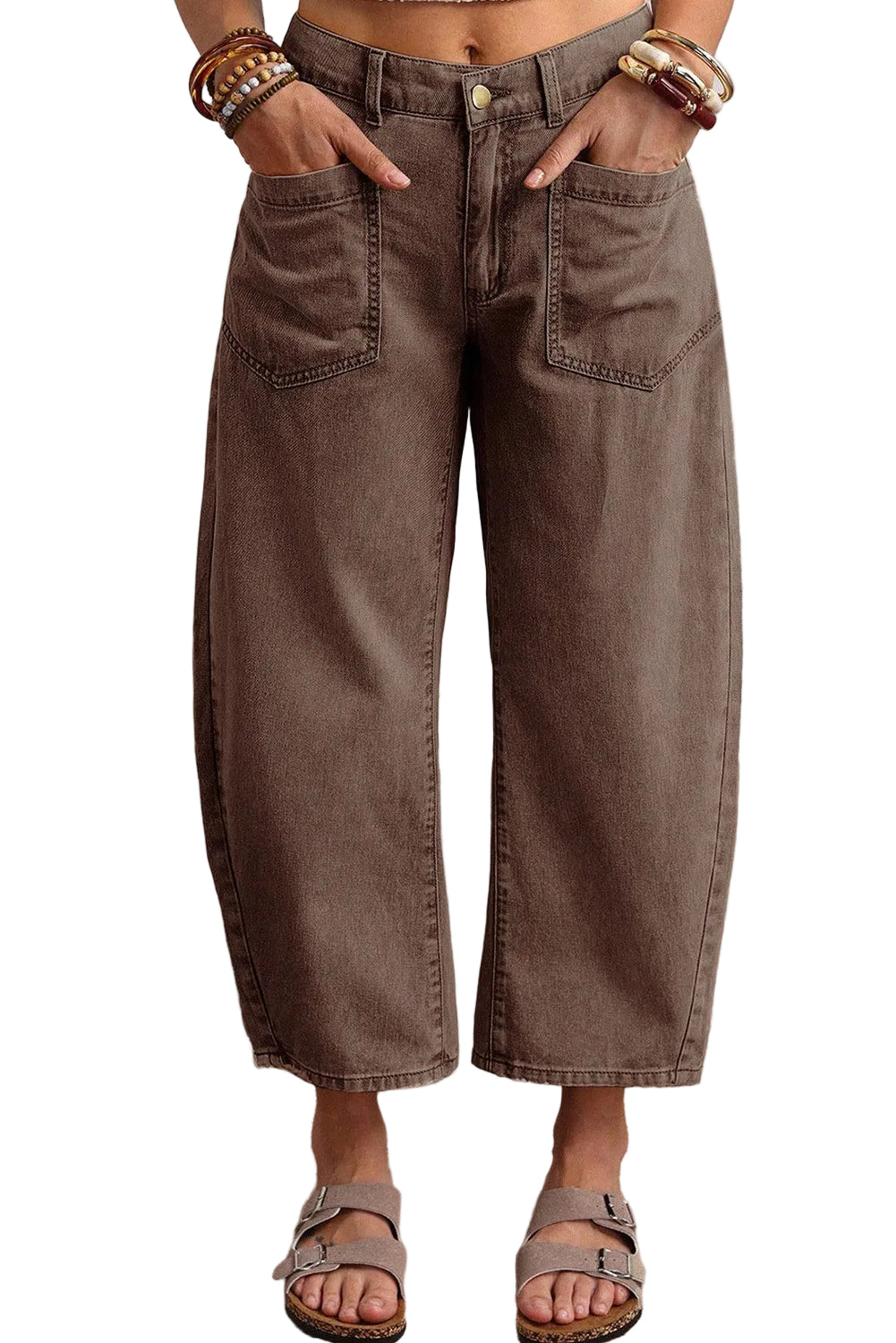 Person wearing brown wide-leg jeans standing on a carpeted floor.