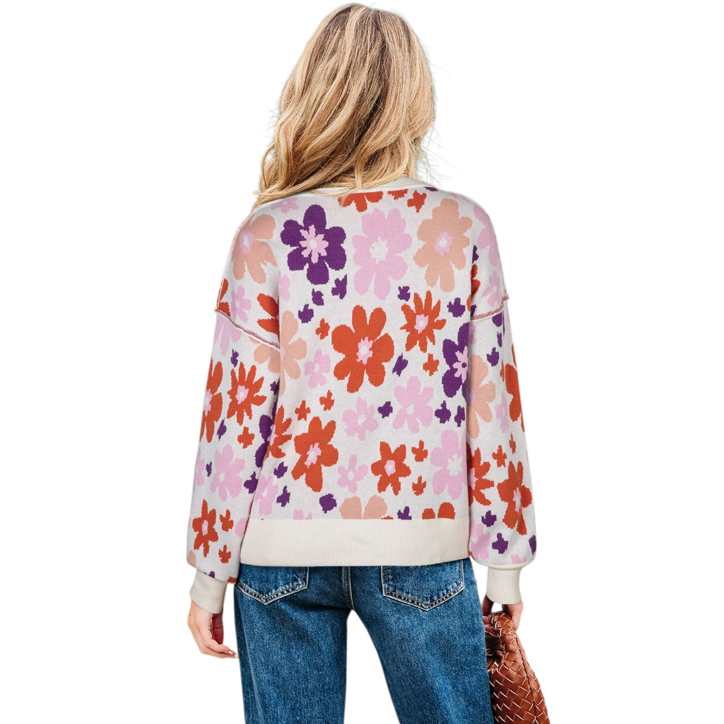Person wearing a colorful floral-patterned sweater on a white background