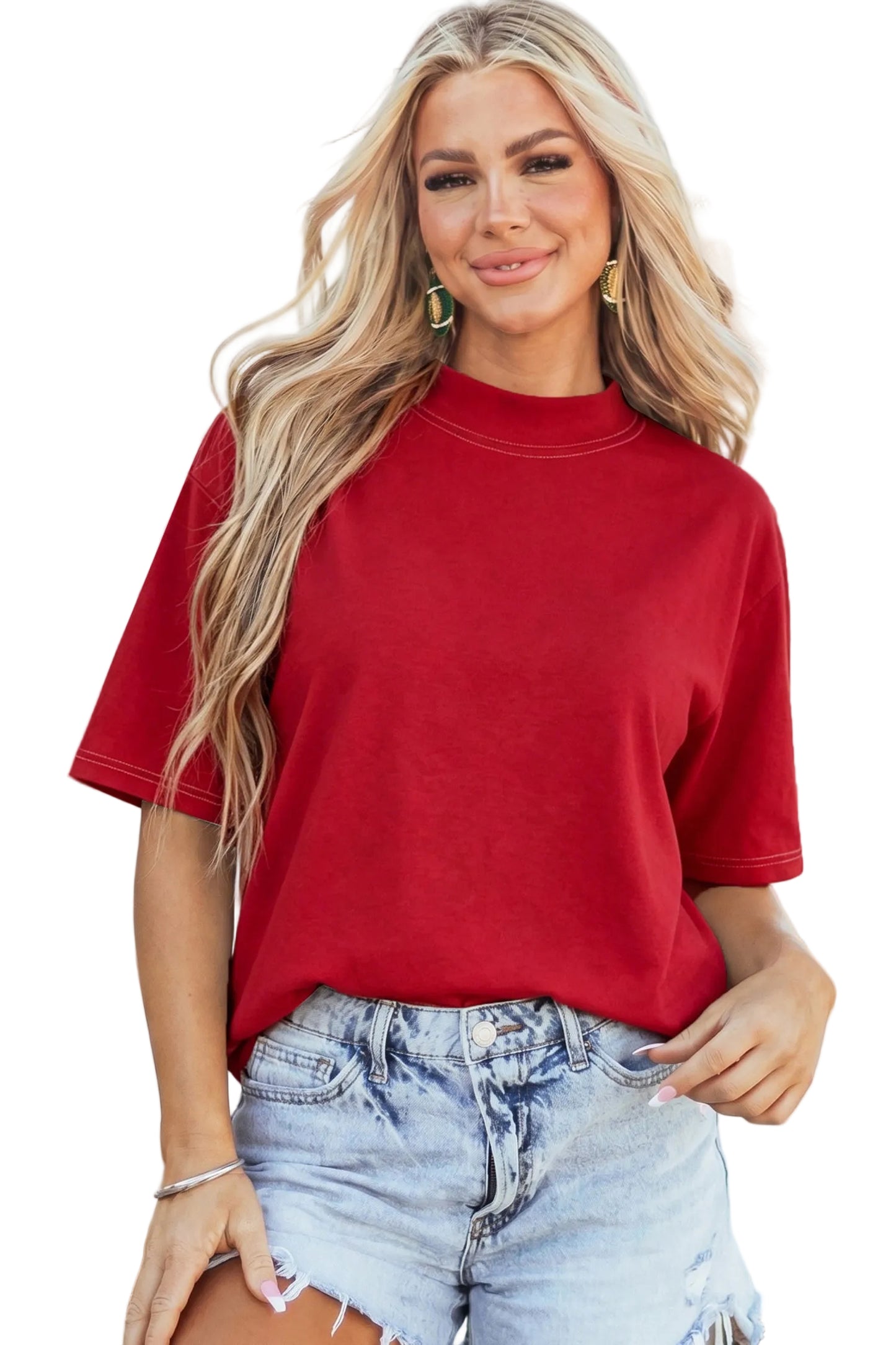 Model wearing a crimson red drop-shoulder basic tee with white structural exposed contrast stitching paired with light denim shorts.