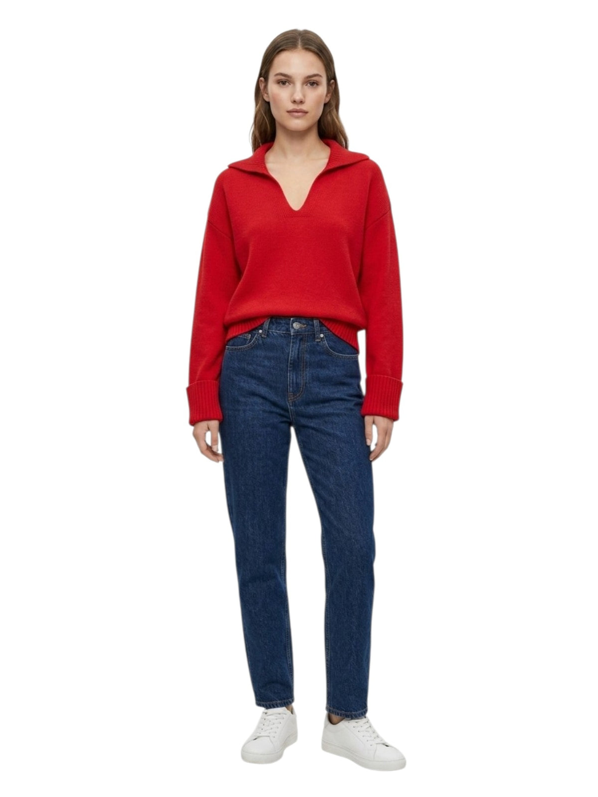 A woman modeling a bright red long-sleeve knit top with a split V-neck and dark blue jeans against a plain white background.