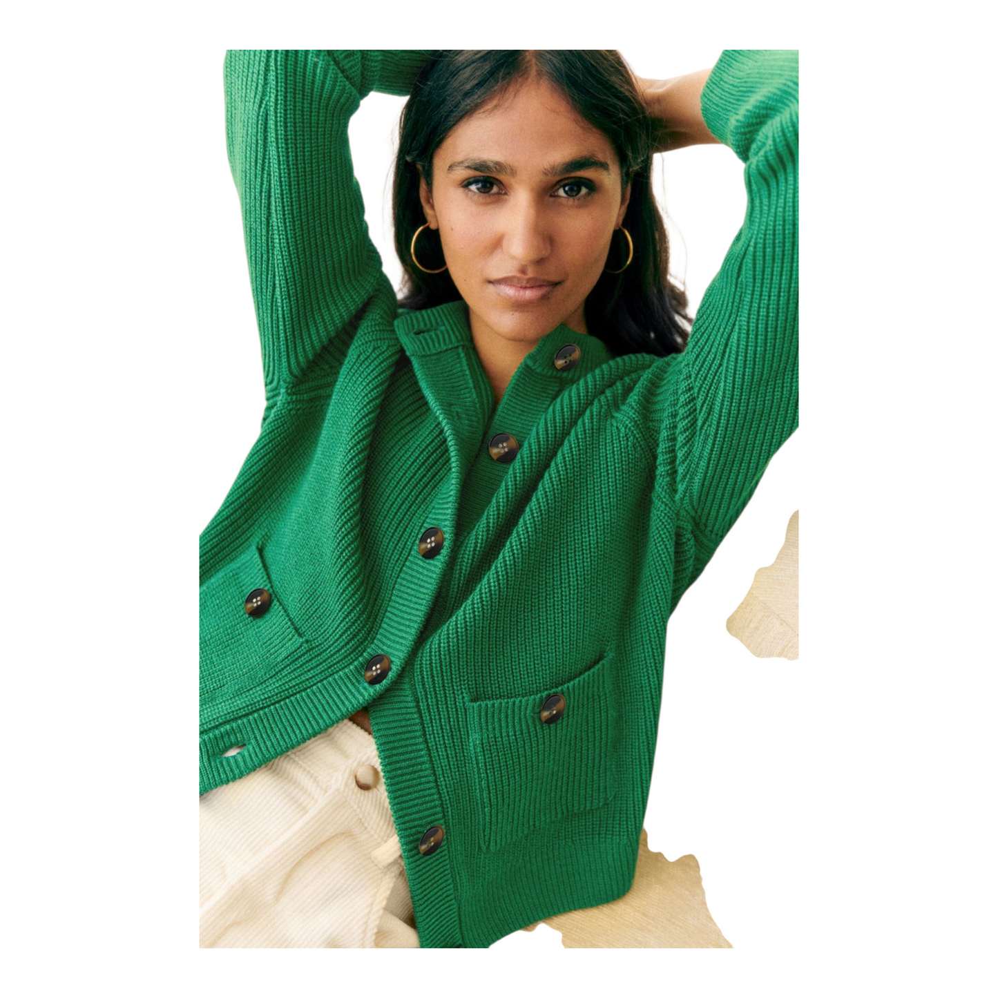Woman wearing a green cardigan with button details on a white background