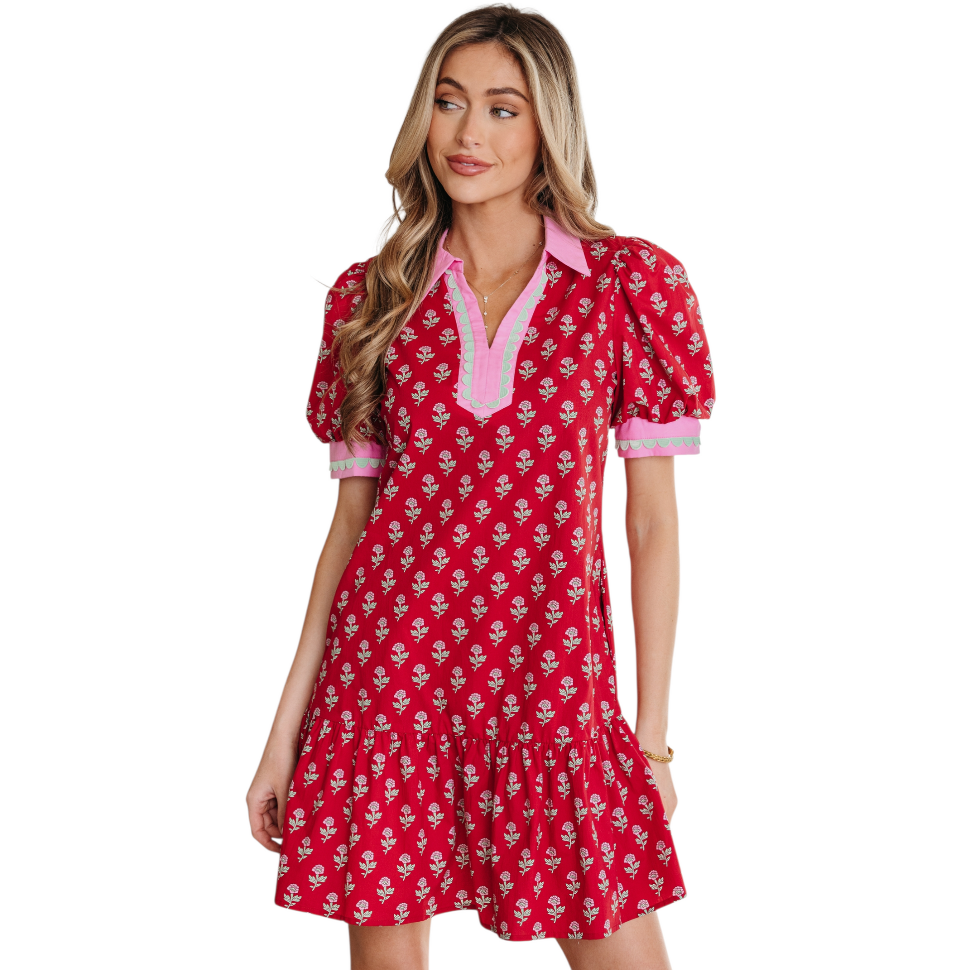 Woman wearing a red floral cotton mini dress with pink ricrac trim, V-neckline, and puff sleeves.