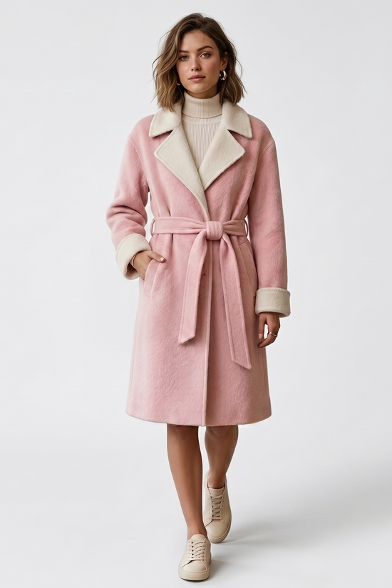 Woman wearing a pink coat with a white collar on a white background