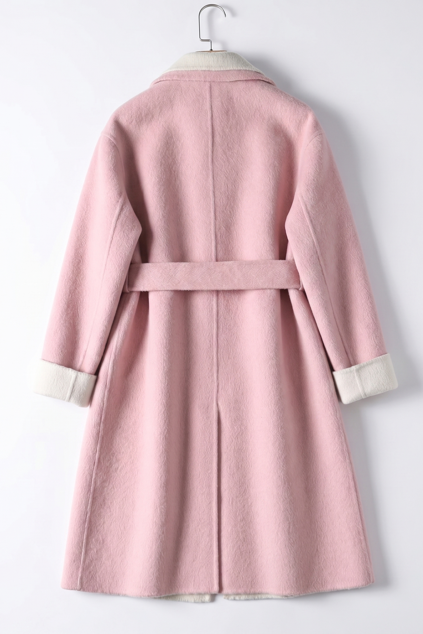Rear view of the rose wool wrap coat showing the structured back seam, waist belt placement, and functional back hem vent.