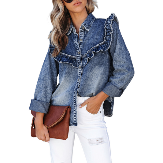 Woman wearing a denim jacket with ruffled details and white pants, holding a brown clutch.