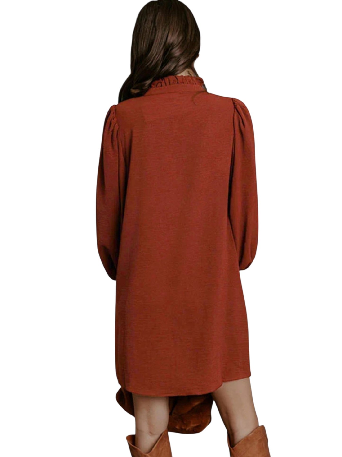 A woman shown from the back wearing a rust-orange long-sleeve tunic dress with a high-low hem and brown boots, set against a plain white background.