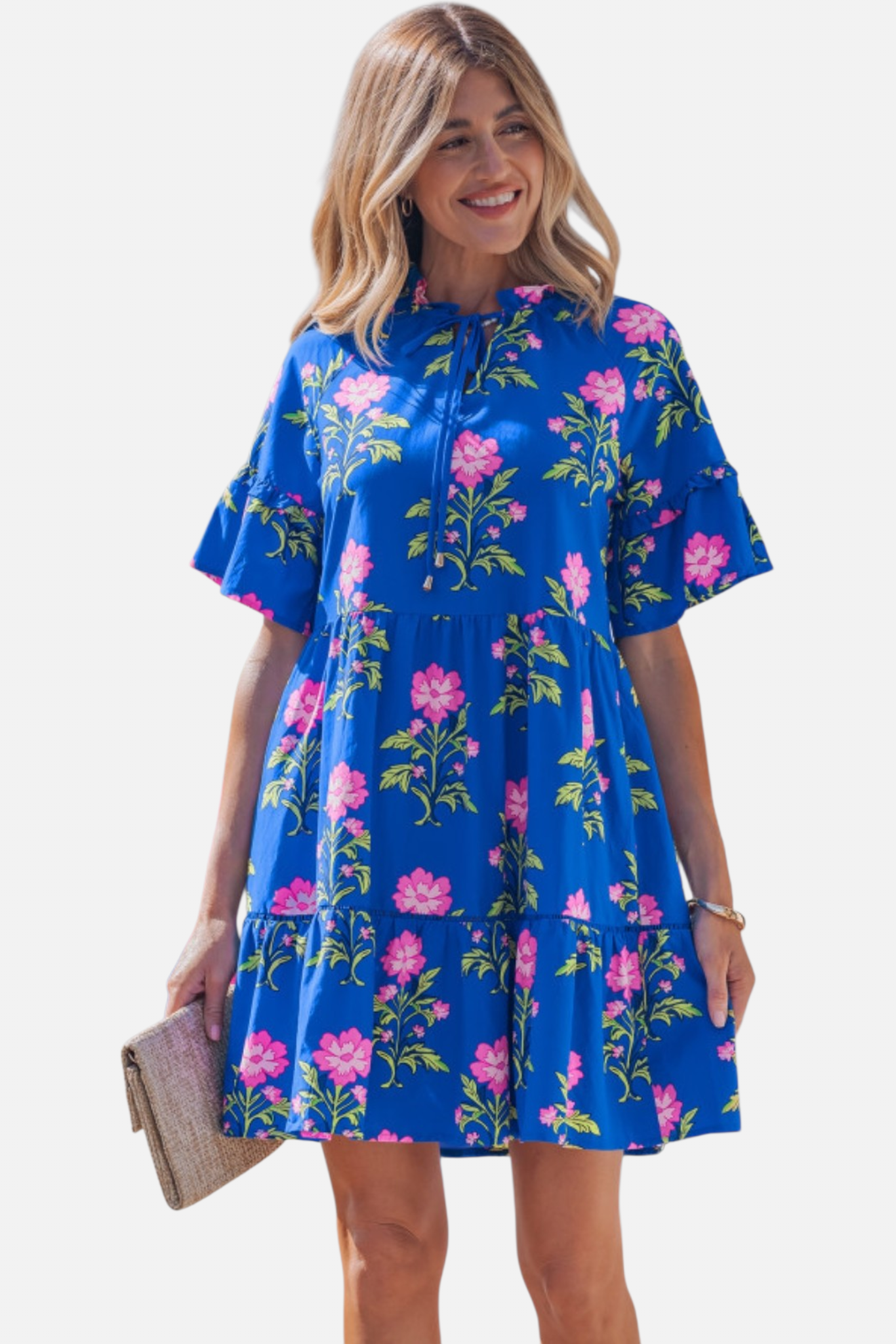 A smiling model showcasing the pink and blue floral ruffle dress, emphasizing a cheerful and effortless summer-ready aesthetic.