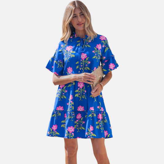 Studio-style front shot of the tiered floral mini dress, highlighting the flattering V-neck opening and relaxed-fit ruffled sleeves.