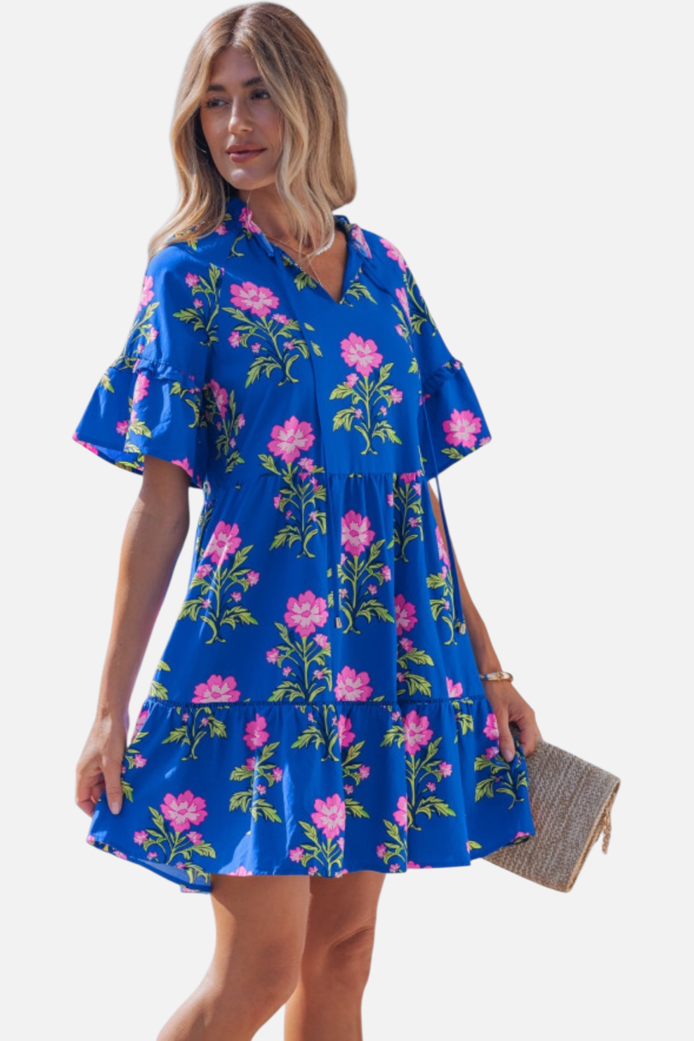 Side profile of the tiered mini dress, illustrating the soft drape of the cotton-viscose fabric and the feminine movement of the flared sleeves.