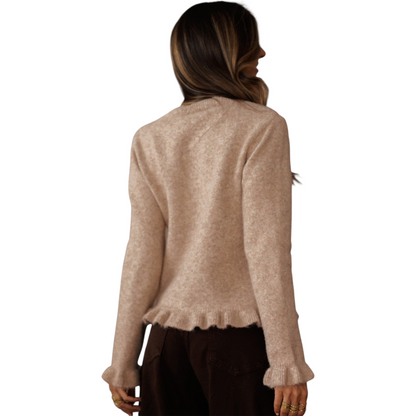 Woman wearing a beige sweater on a white background
