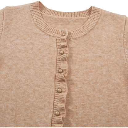 Close-up of a beige knitted cardigan with button details on a white background
