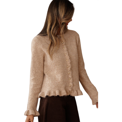 Woman wearing a beige sweater with a white background