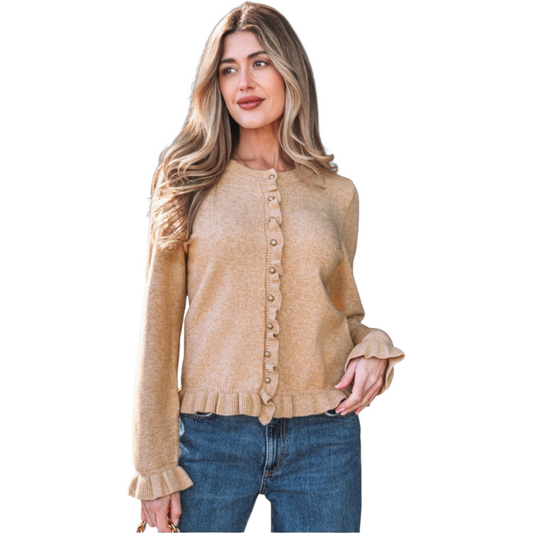 A woman wearing a camel-coloured, long-sleeve knit cardigan featuring feminine ruffle trim along the hem, cuffs, and button placket with small gold buttons.