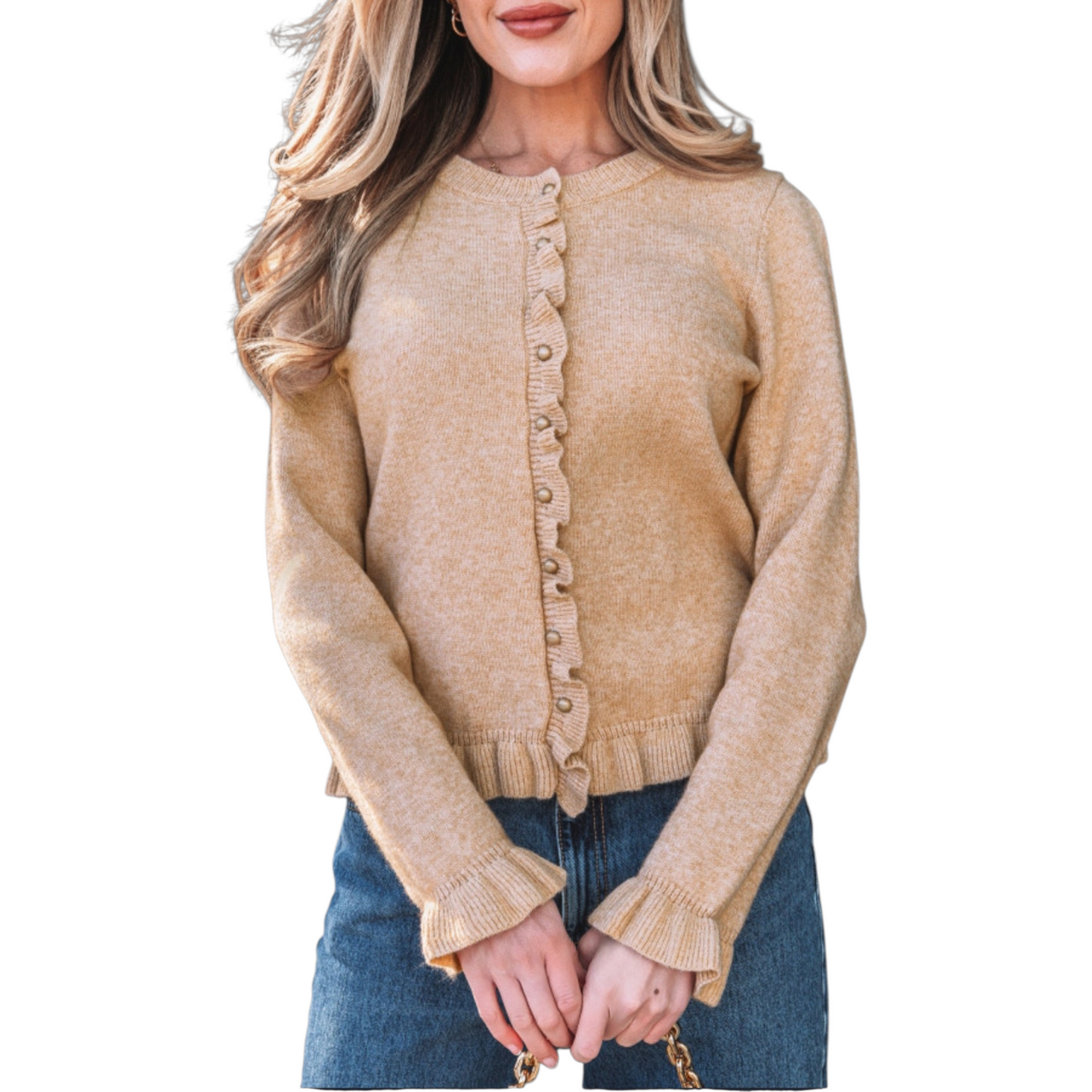 A woman wearing a camel-coloured, long-sleeve knit cardigan featuring feminine ruffle trim along the hem, cuffs, and button placket with small gold buttons.
