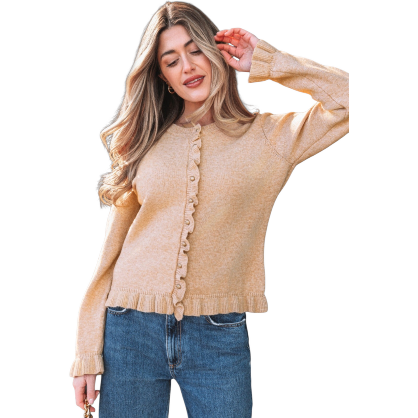 A woman wearing a camel-coloured, long-sleeve knit cardigan featuring feminine ruffle trim along the hem, cuffs, and button placket with small gold buttons.