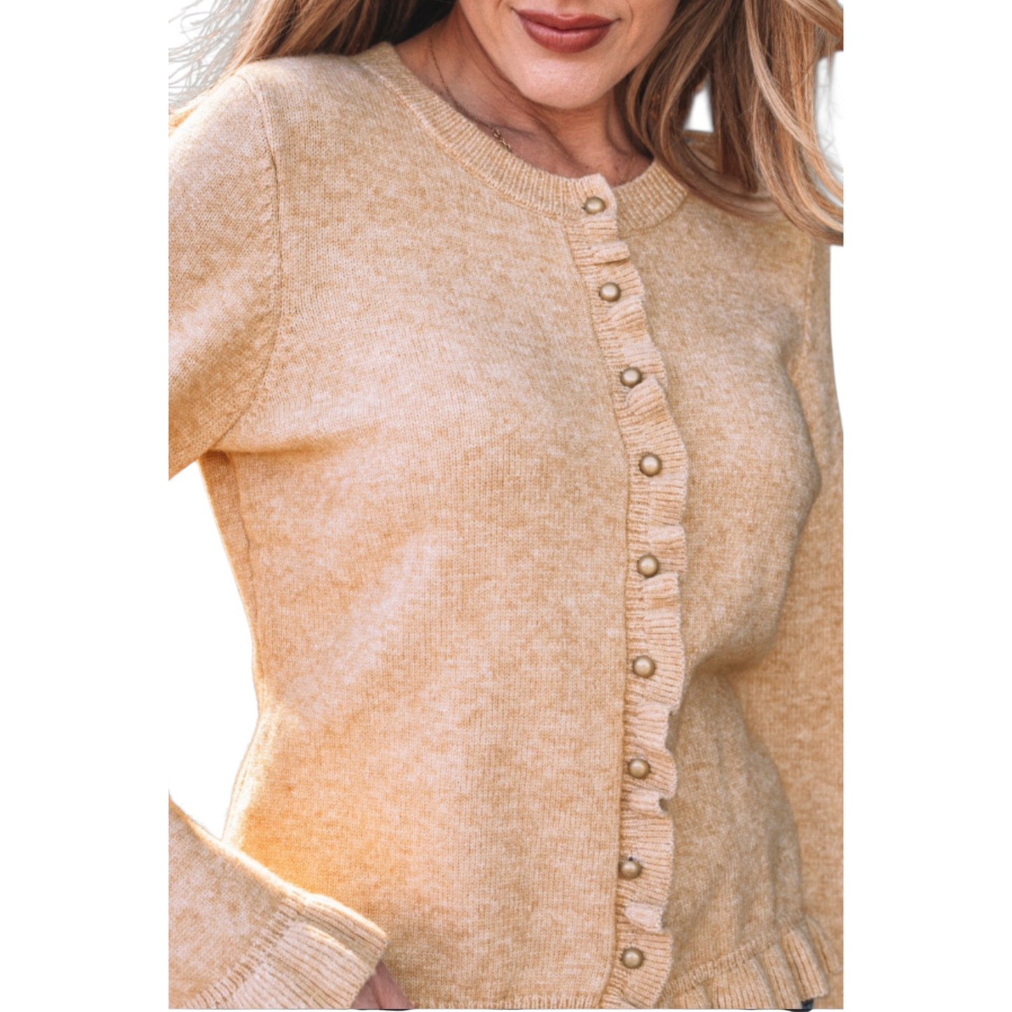 A woman wearing a camel-coloured, long-sleeve knit cardigan featuring feminine ruffle trim along the hem, cuffs, and button placket with small gold buttons. Close-up view.