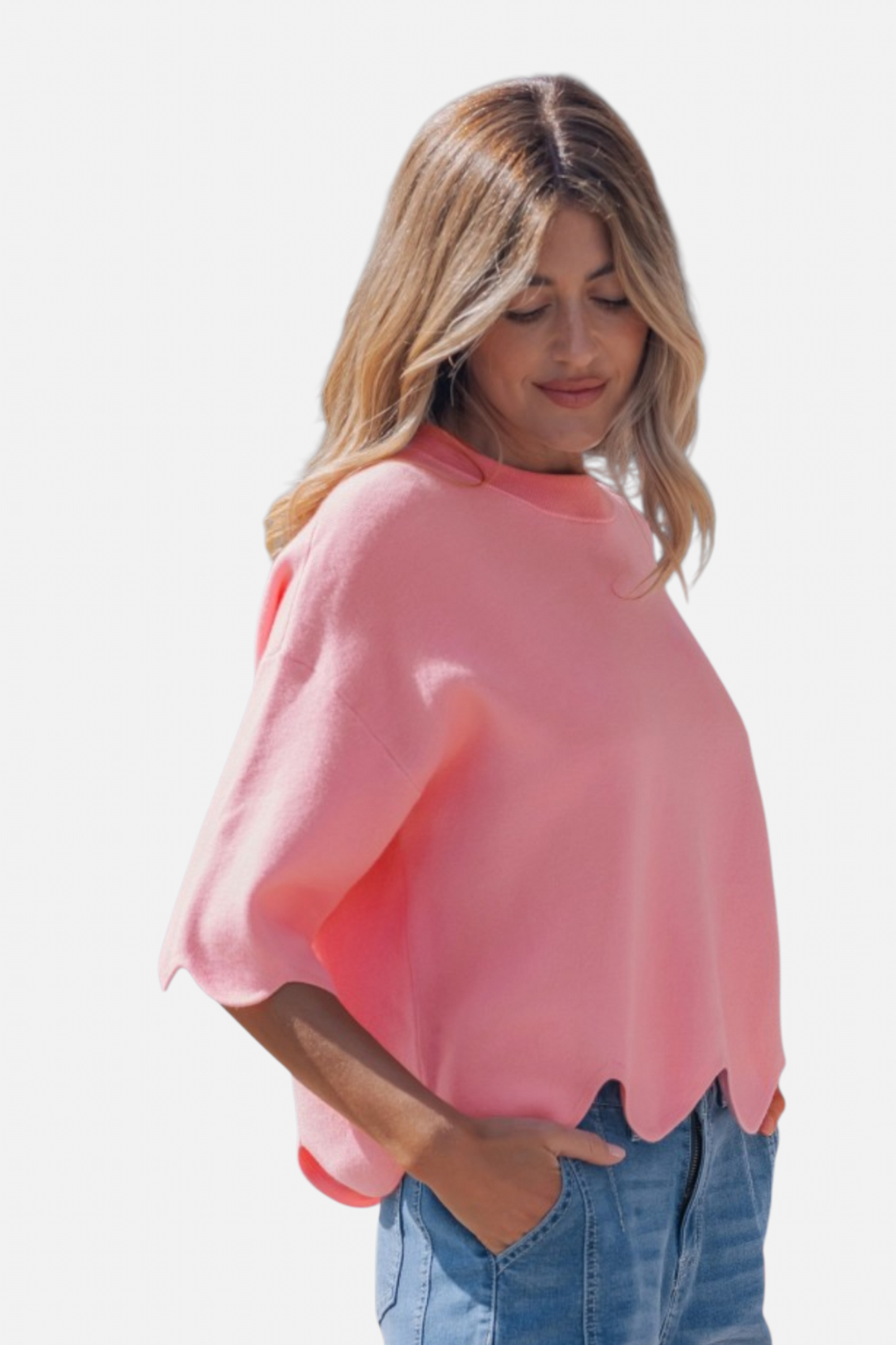 Woman wearing a pink blouse and blue jeans on a white background