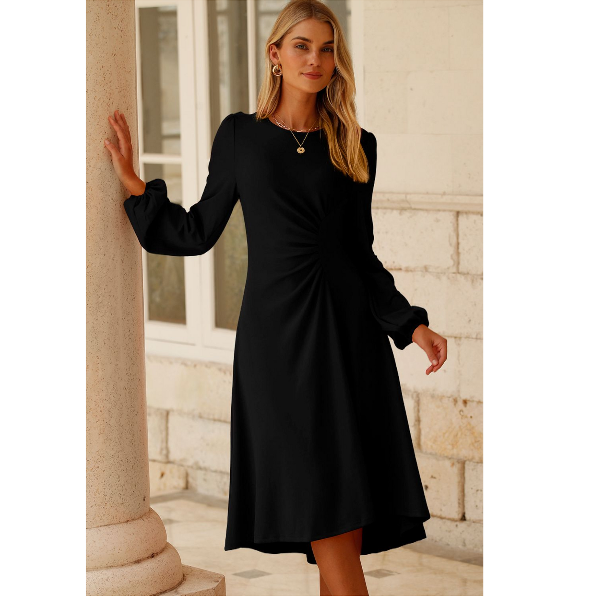 Woman wearing a black dress standing against a stone wall.