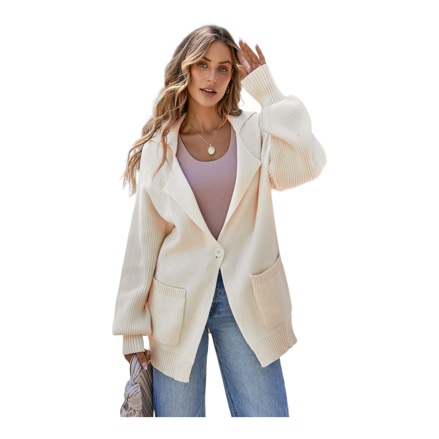 Woman wearing a cream cardigan over a pink top and blue jeans on a white background