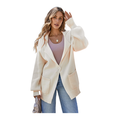 Woman wearing a cream cardigan over a pink top and blue jeans on a white background