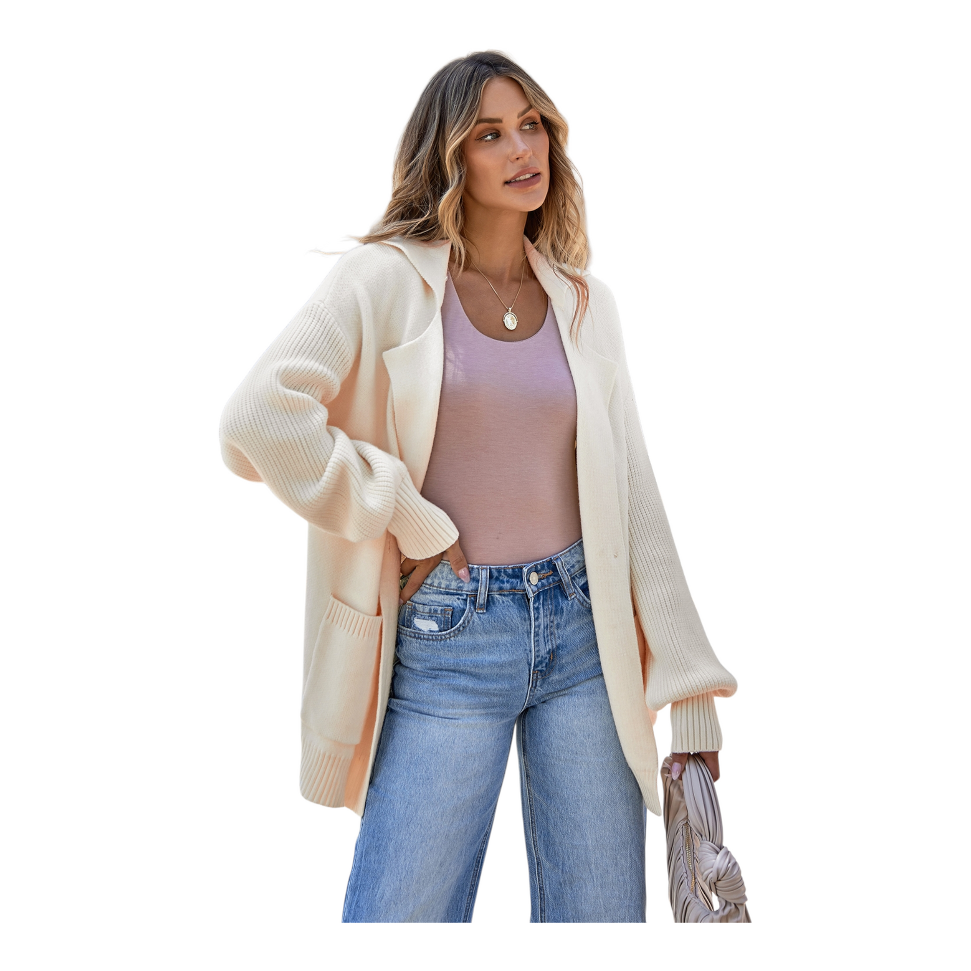 Woman wearing a cream cardigan, pink top, and blue jeans on a white background