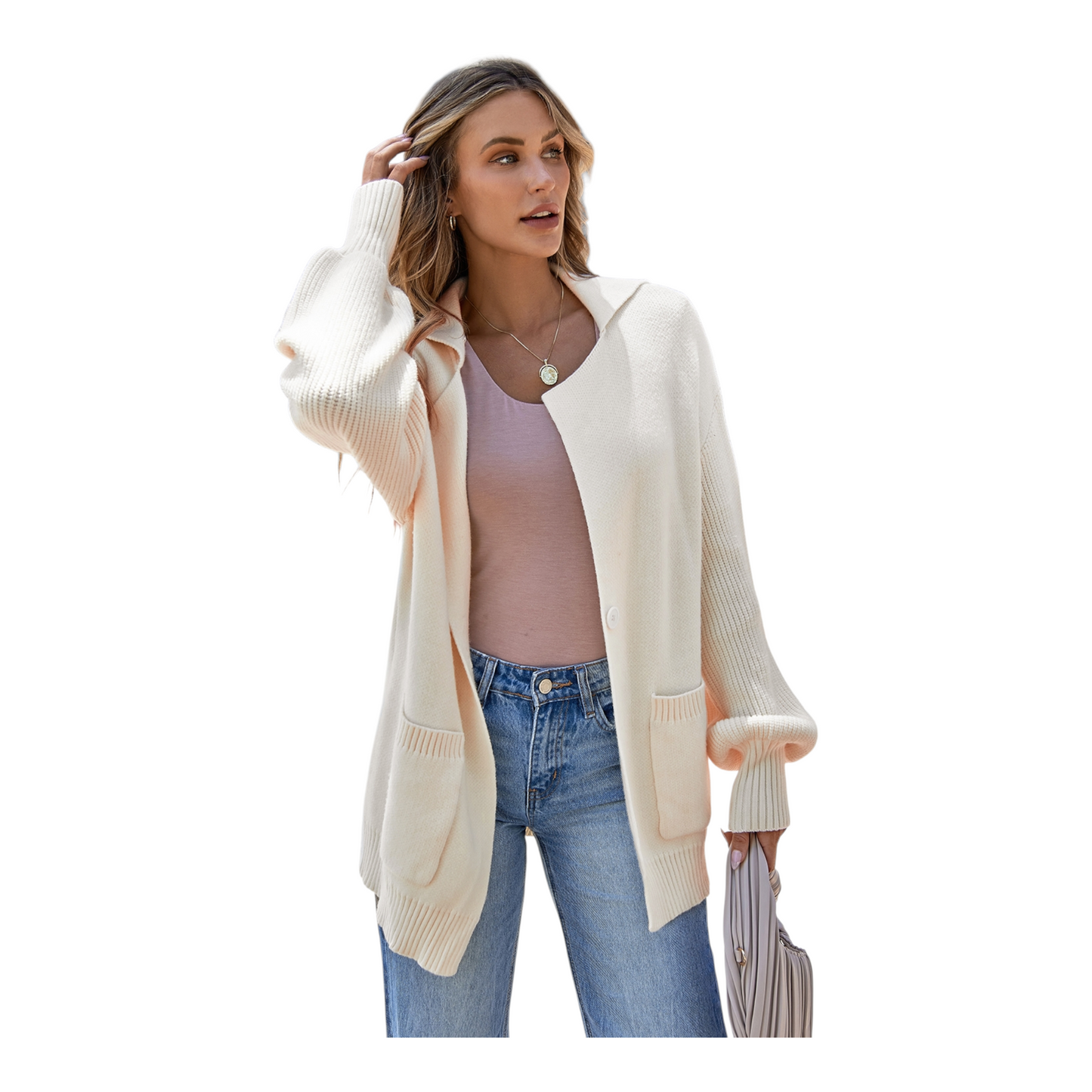 Woman wearing a cream cardigan over a pink top and blue jeans on a white background