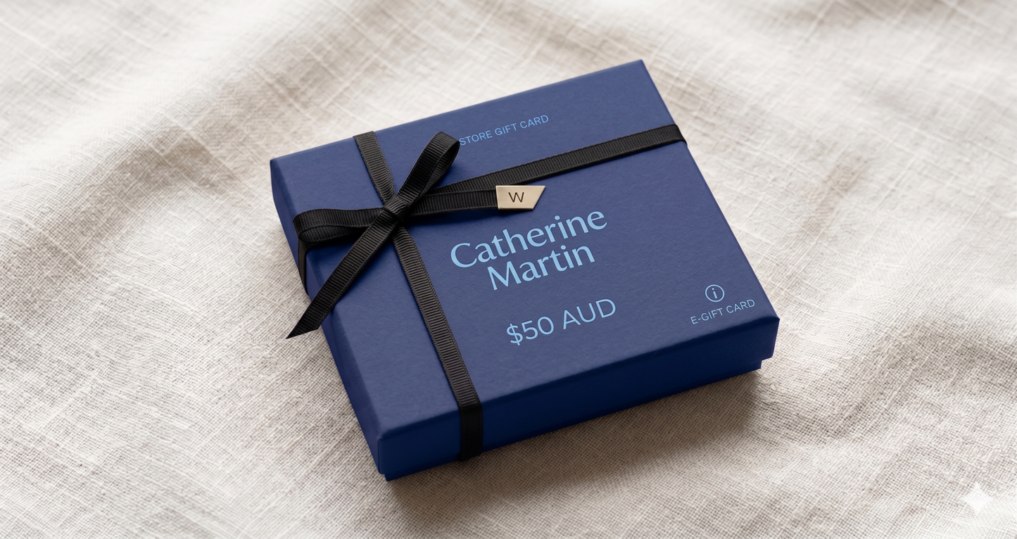 Blue gift card box with black ribbon on a textured surface