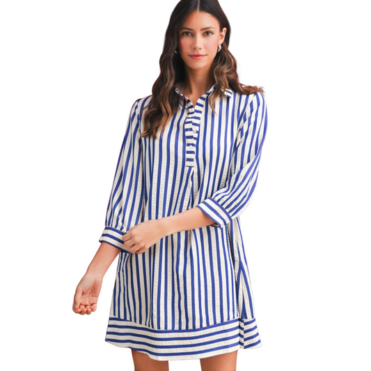Woman wearing a blue and white striped dress on a white background