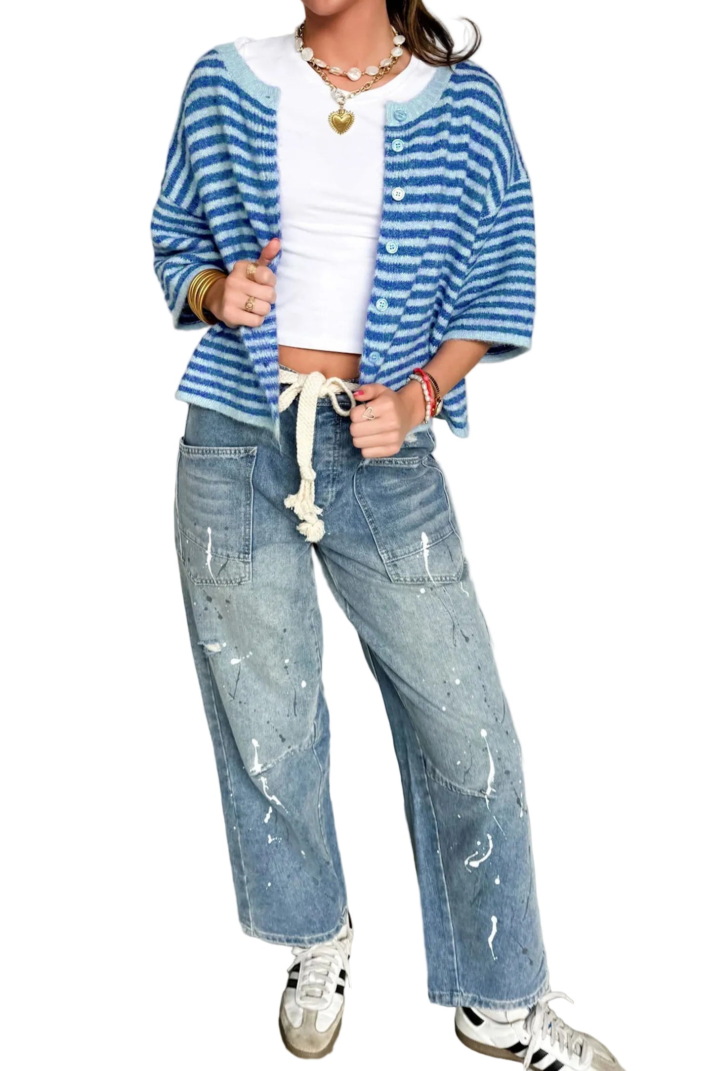 Person wearing a blue and white striped shirt, white crop top, and light blue jeans with a white background