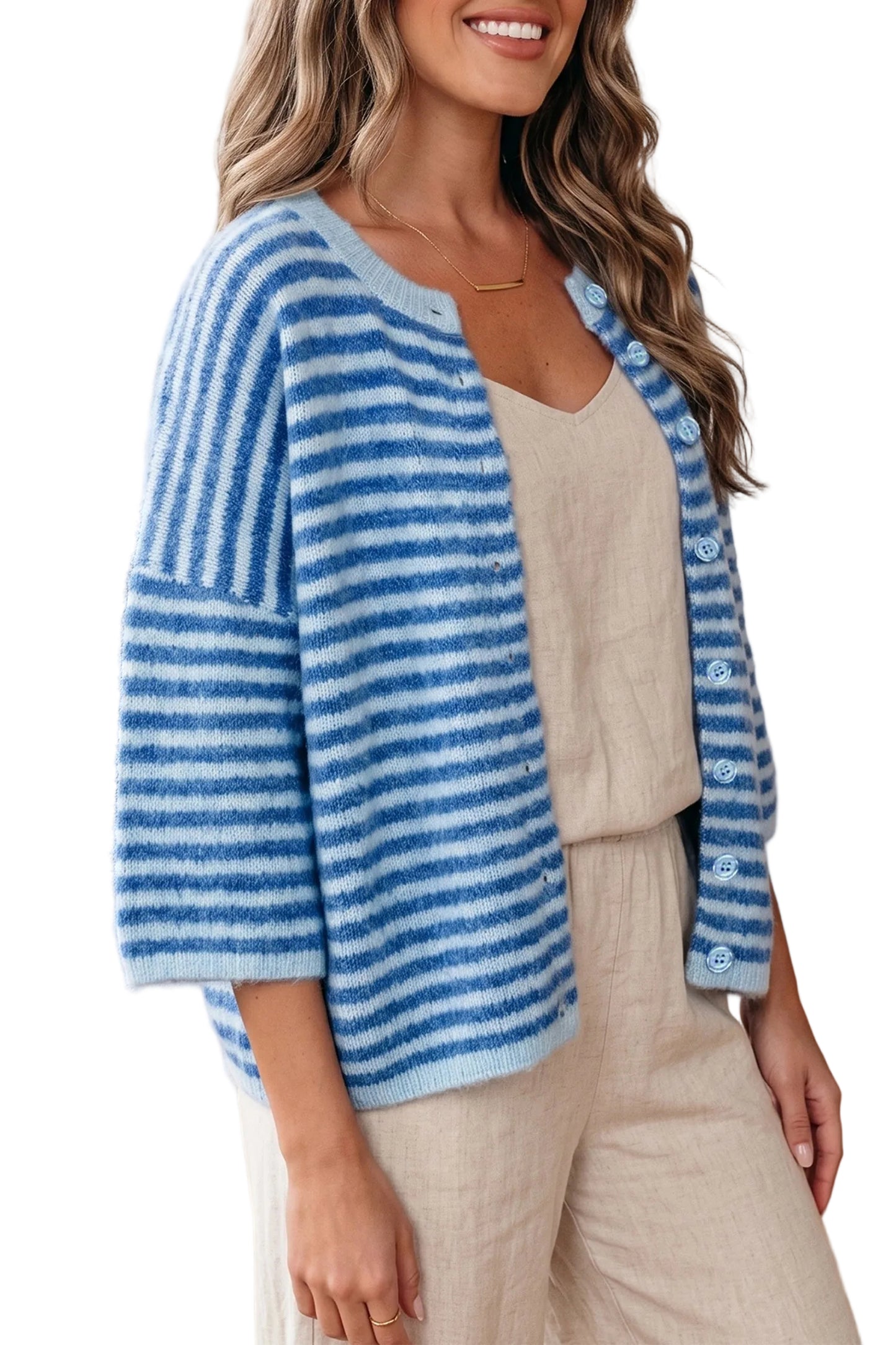Woman wearing a blue and white striped sweater in a white neutral background
