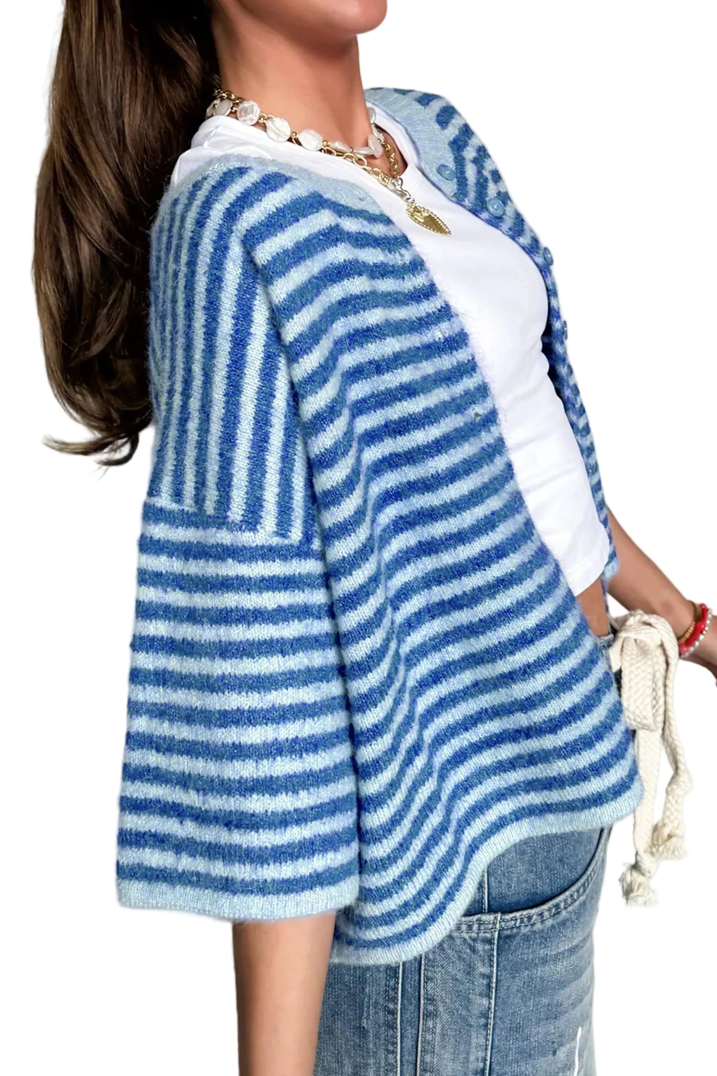 Person wearing a blue and white striped cardigan over a white shirt with a plain background