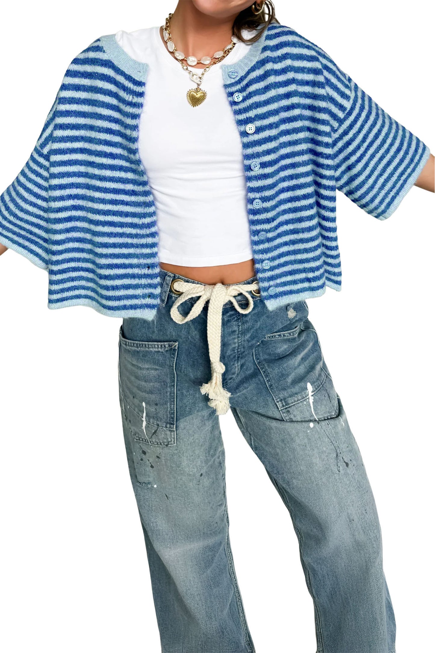 Person wearing a blue and white striped cardigan over a white shirt and blue jeans on a white background