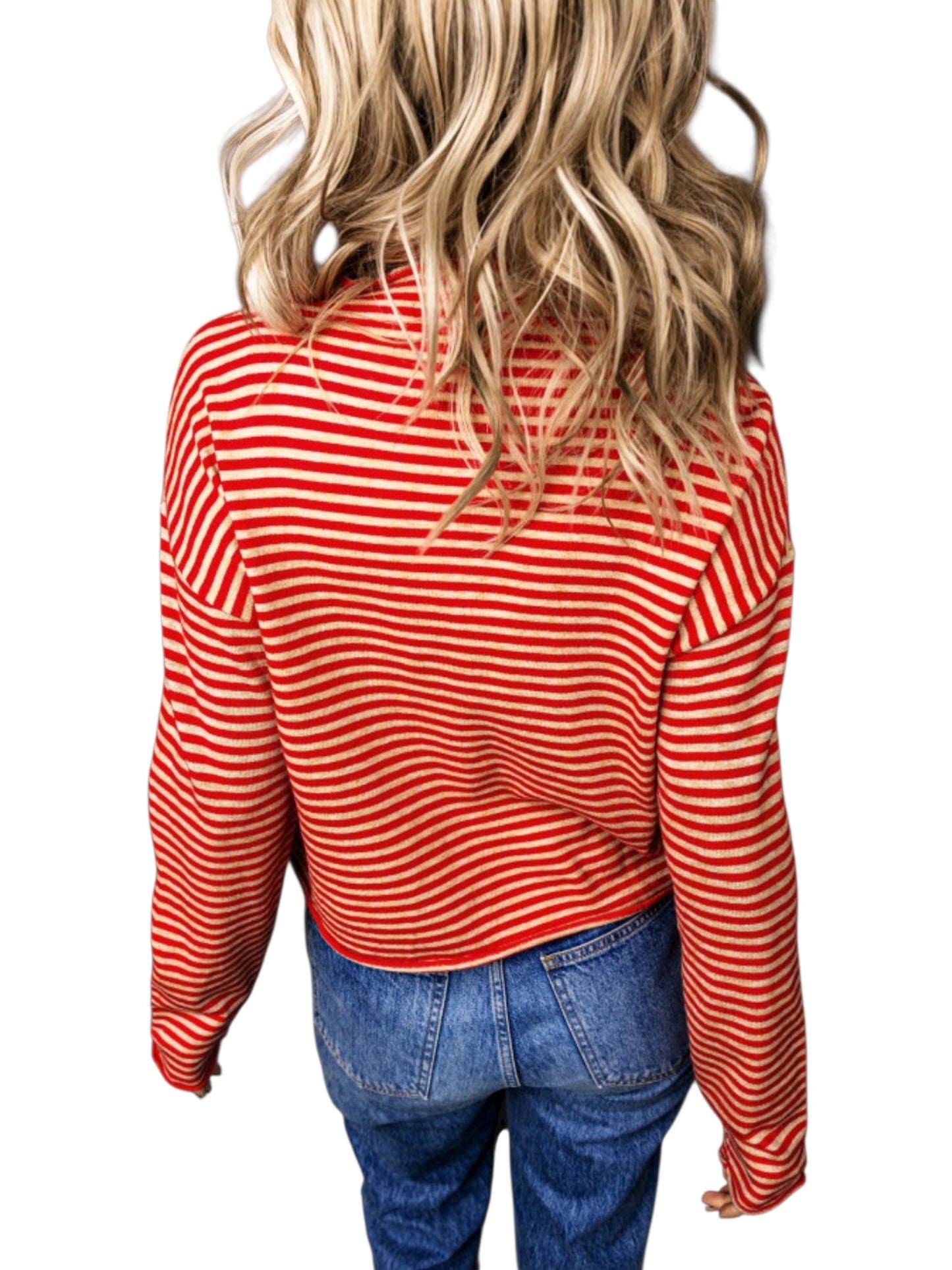 A woman viewed from the back wearing a red and white horizontally striped long-sleeve crop top and blue jeans, set against a plain white background.