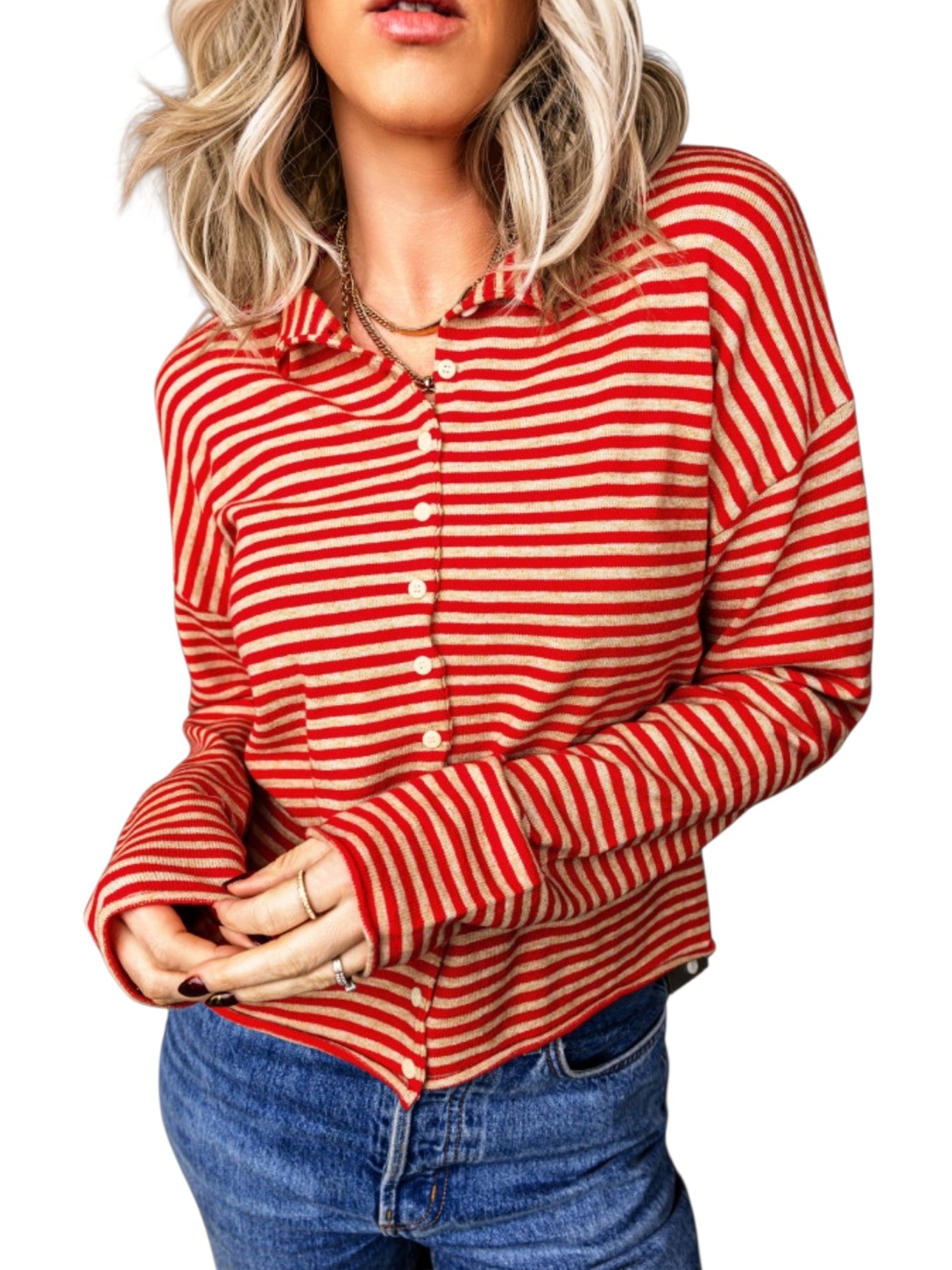 A woman wearing a red and white striped long-sleeve button-up shirt with blue jeans, shown from the lips down against a plain white background.