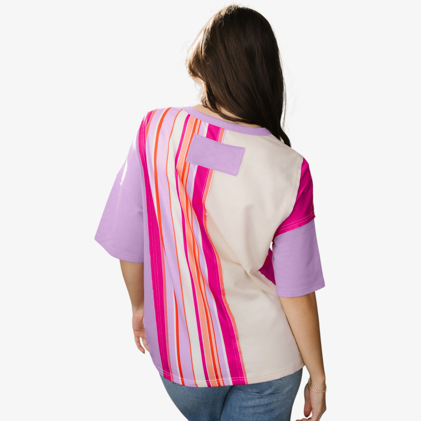 Woman wearing a colorful striped shirt with a white background