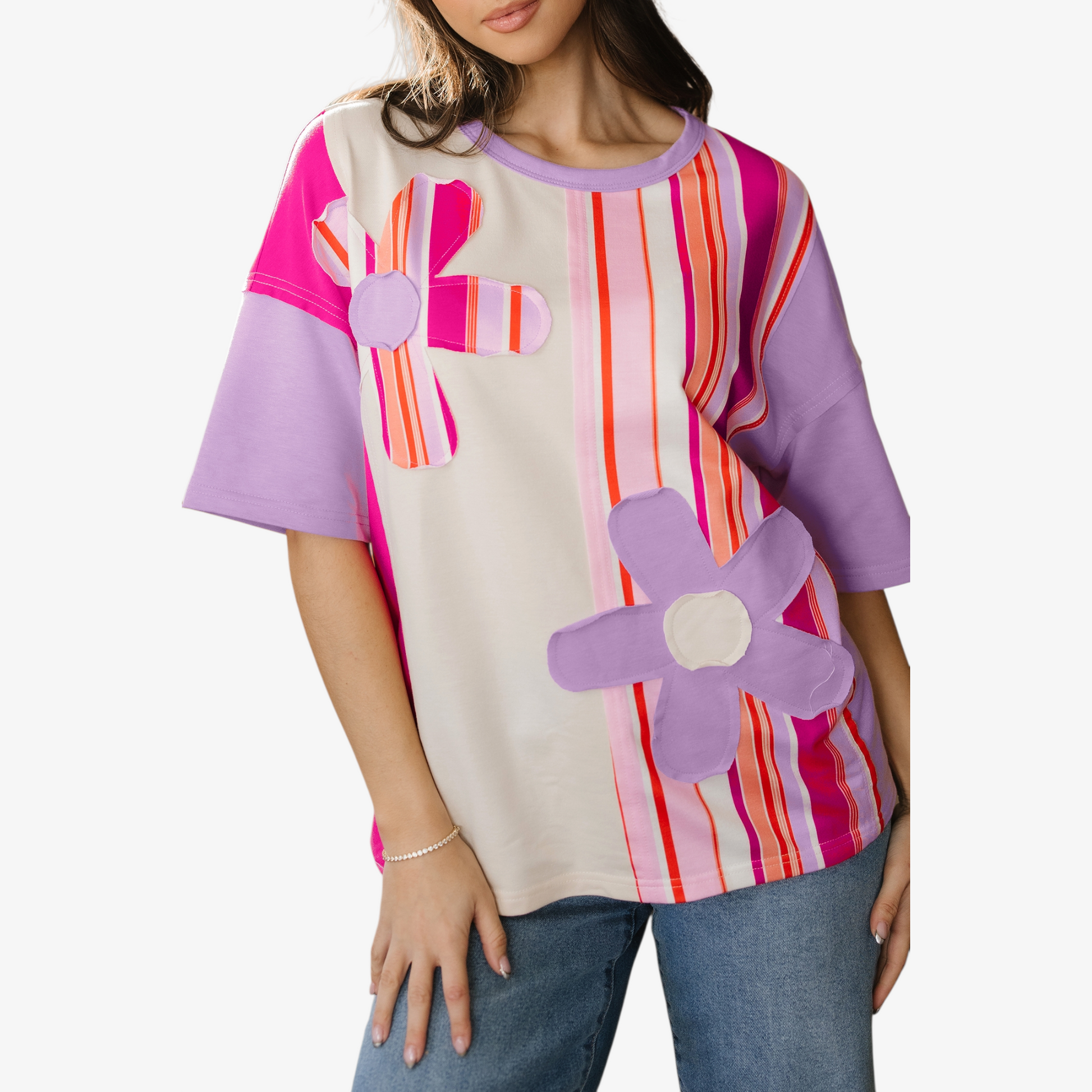 Woman wearing a colorful shirt with floral designs on a white background