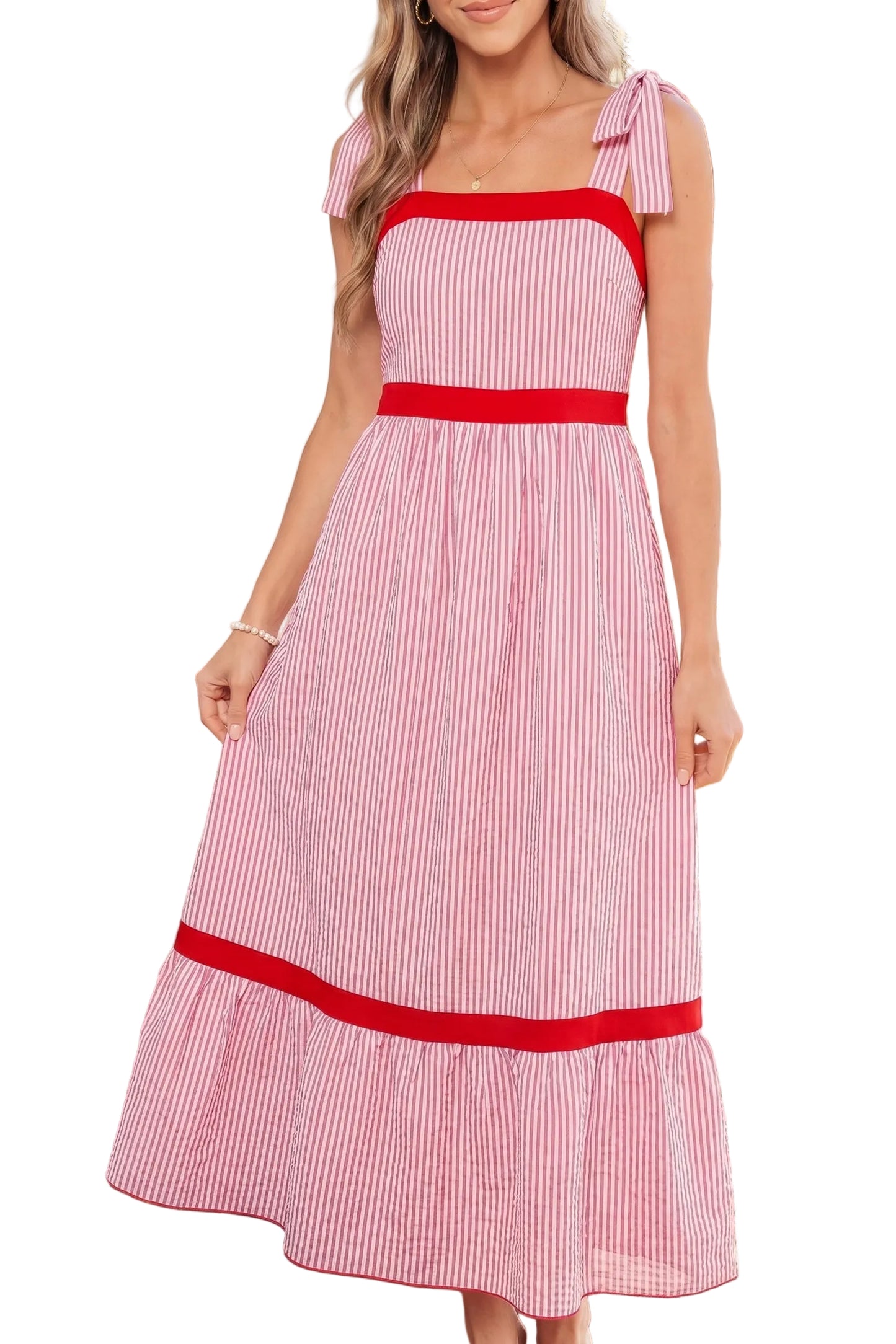 Woman wearing a red and white striped dress with a white background