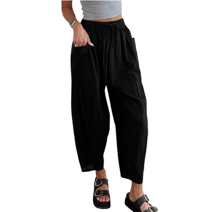 Black wide-leg pants worn by a person on a white background