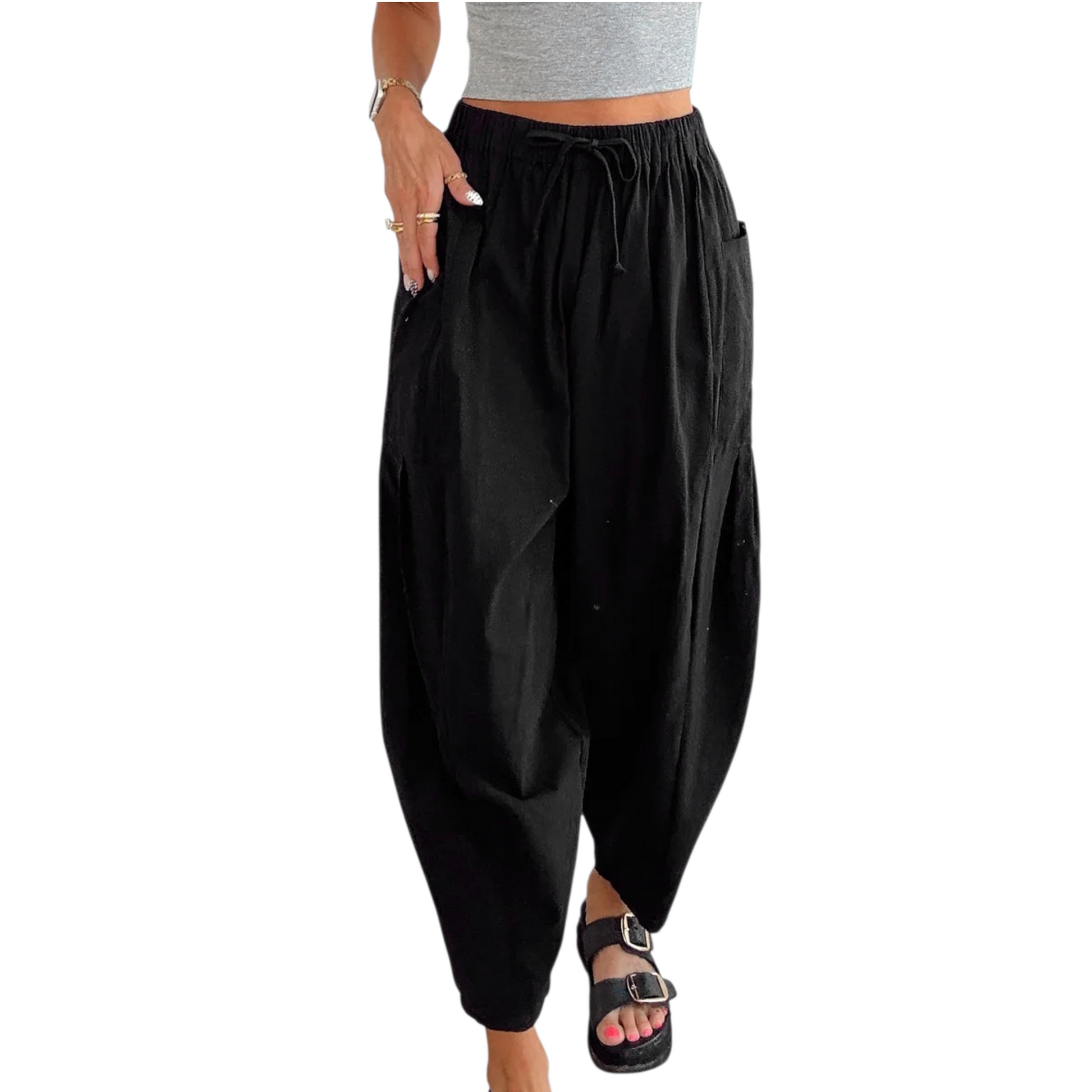 Black harem pants worn by a person on a white background