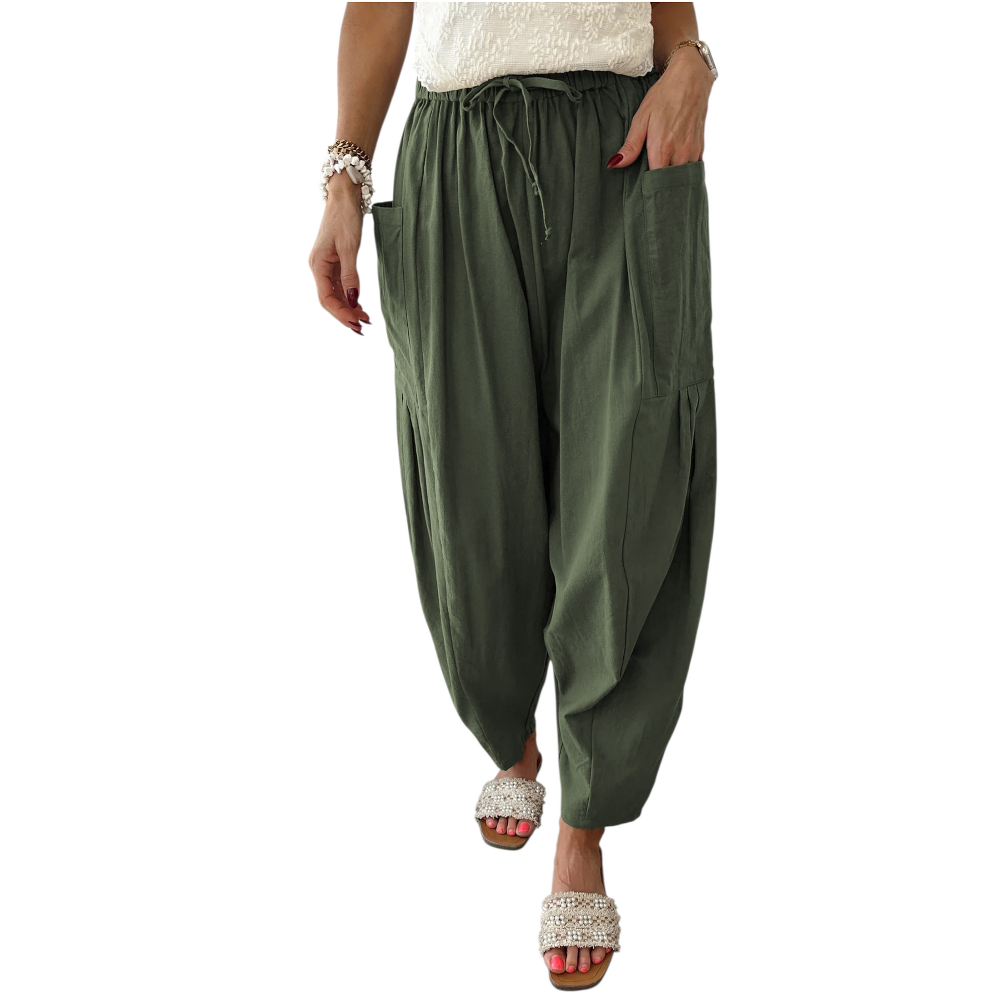 Green harem pants worn by a person on a white background