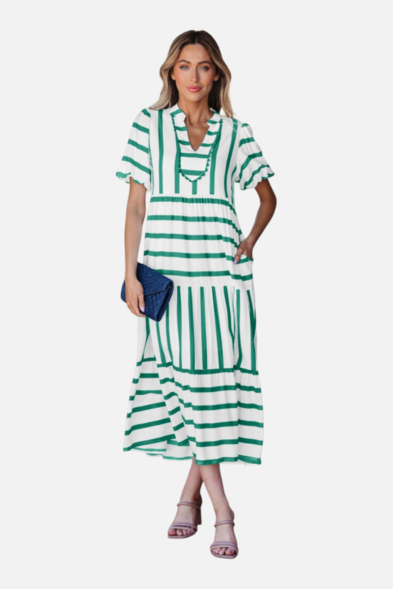 A model showcasing the green striped midi dress, featuring a notched V-neckline with blue ricrac trim, puff sleeves, and a tiered skirt in a vacation-ready 100% viscose fabric.
