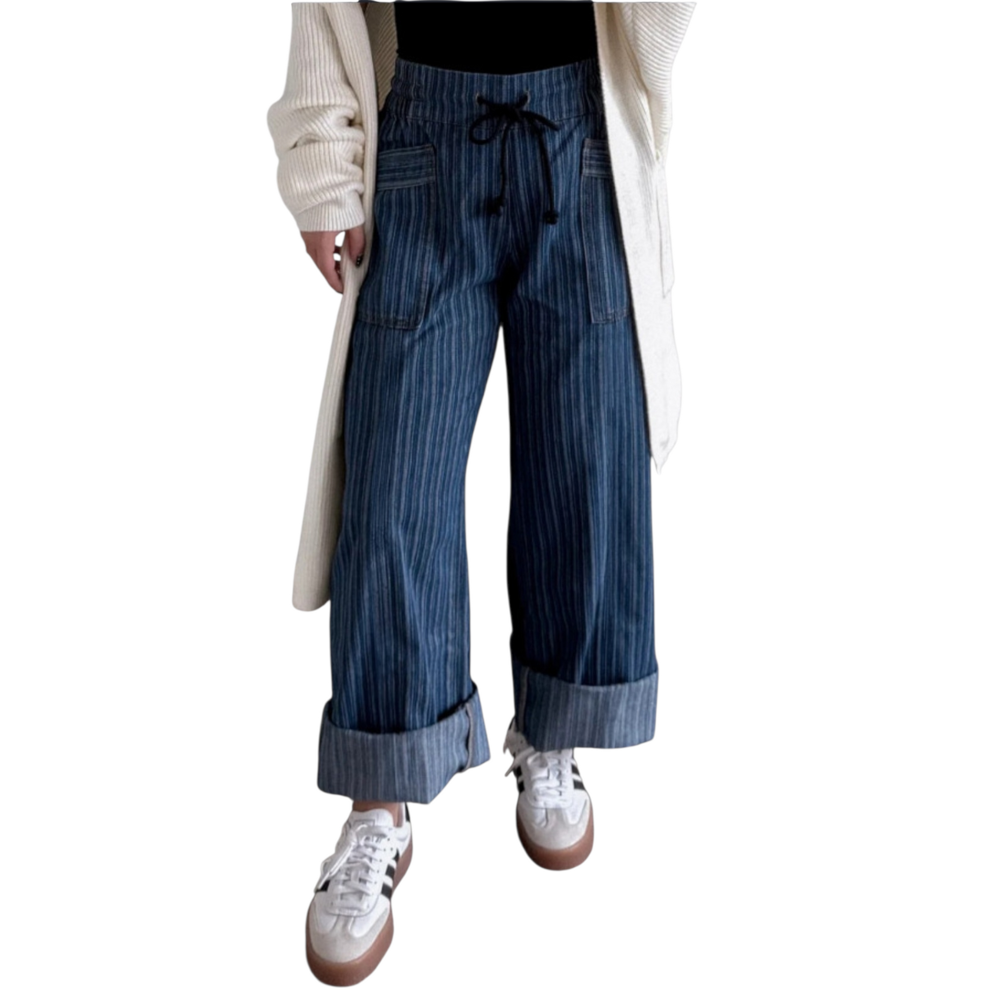 Person wearing wide-leg, blue pinstriped drawstring pants with cuffed hems, paired with white sneakers and white cardigan.