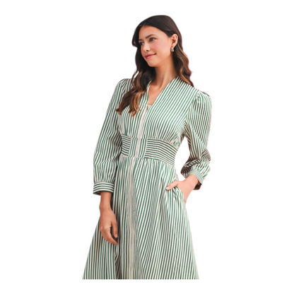 Woman wearing a green and white striped dress on a white background