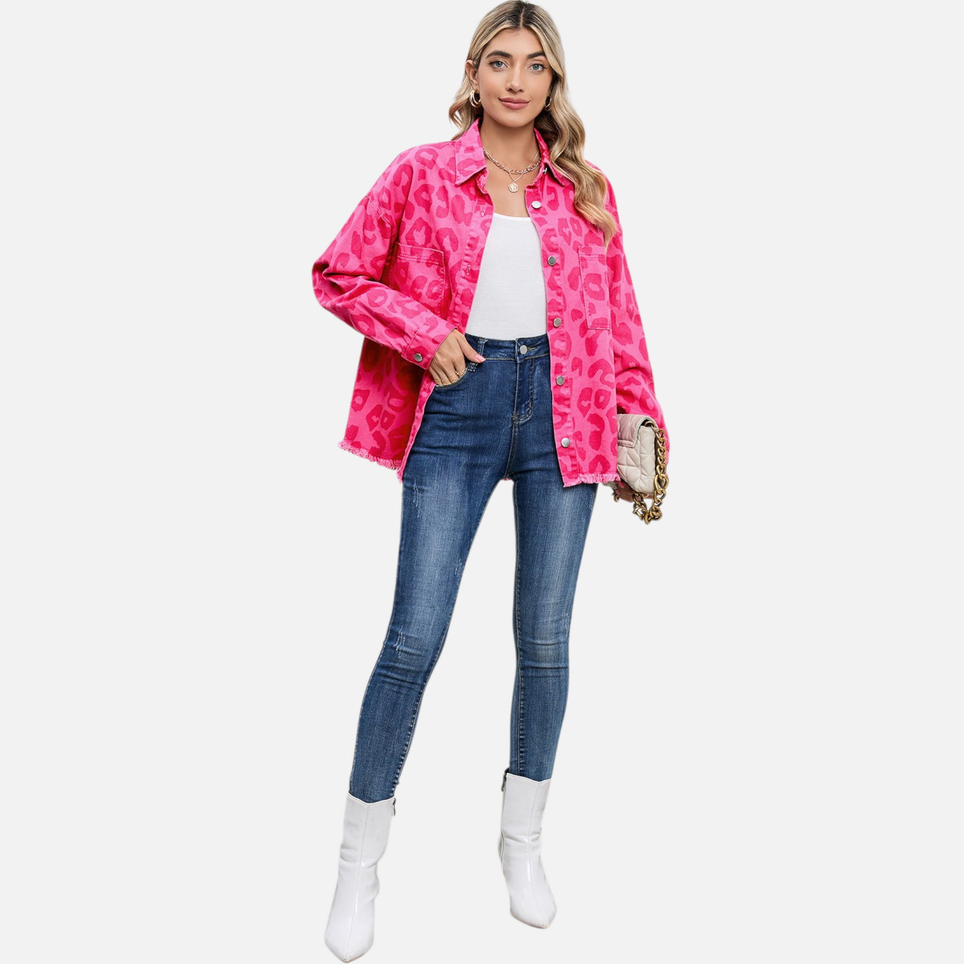 A full-length lifestyle shot featuring a model in the complete outfit: the pink leopard print denim jacket, blue skinny jeans, and white pointed-toe boots, providing a complete "Shop the Look" perspective.