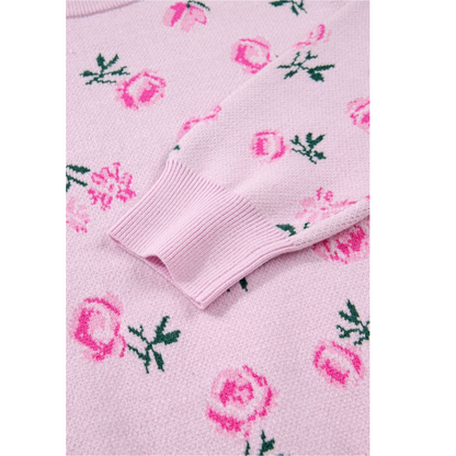 Close-up of a pink sweater with floral patterns on a white background